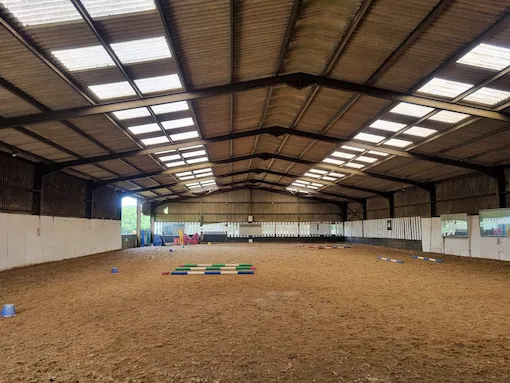 indoor riding hall at hewshott farm stables